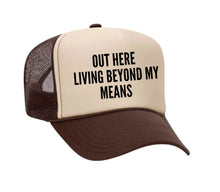 Load image into Gallery viewer, Out Here Living Beyond My Means Trucker Hat
