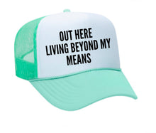 Load image into Gallery viewer, Out Here Living Beyond My Means Trucker Hat

