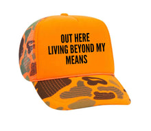 Load image into Gallery viewer, Out Here Living Beyond My Means Trucker Hat
