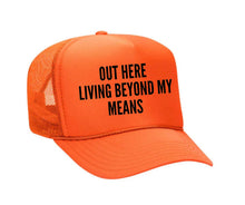 Load image into Gallery viewer, Out Here Living Beyond My Means Trucker Hat
